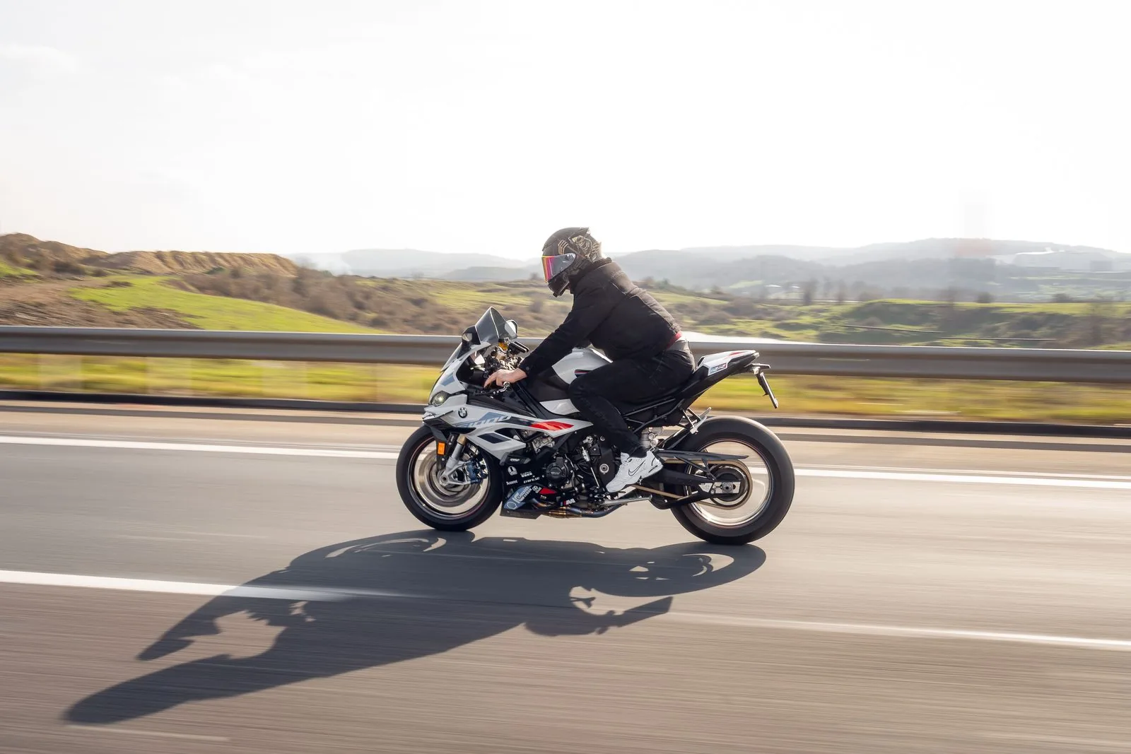 Motorcyclist riding on an open Los Angeles highway in daylight